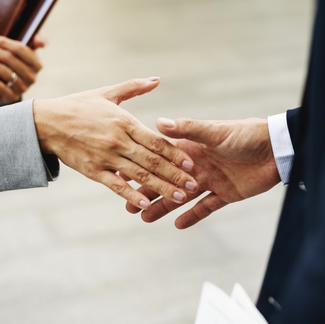 two people about to shake hands